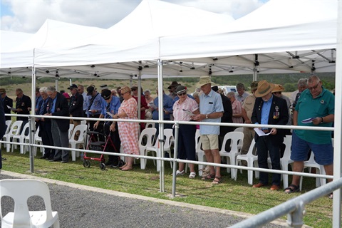 United_in_remembrance___Attendees_stand_in_reflection_at_the_Canal_Creek_Memorial_Service.jpg