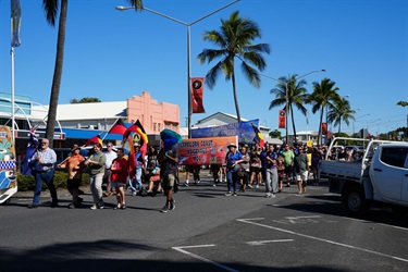 People marching in a street parade with banners reading “Capricorn Coast Sea Country” and “Capricorn Coast Indigenous Mob”.