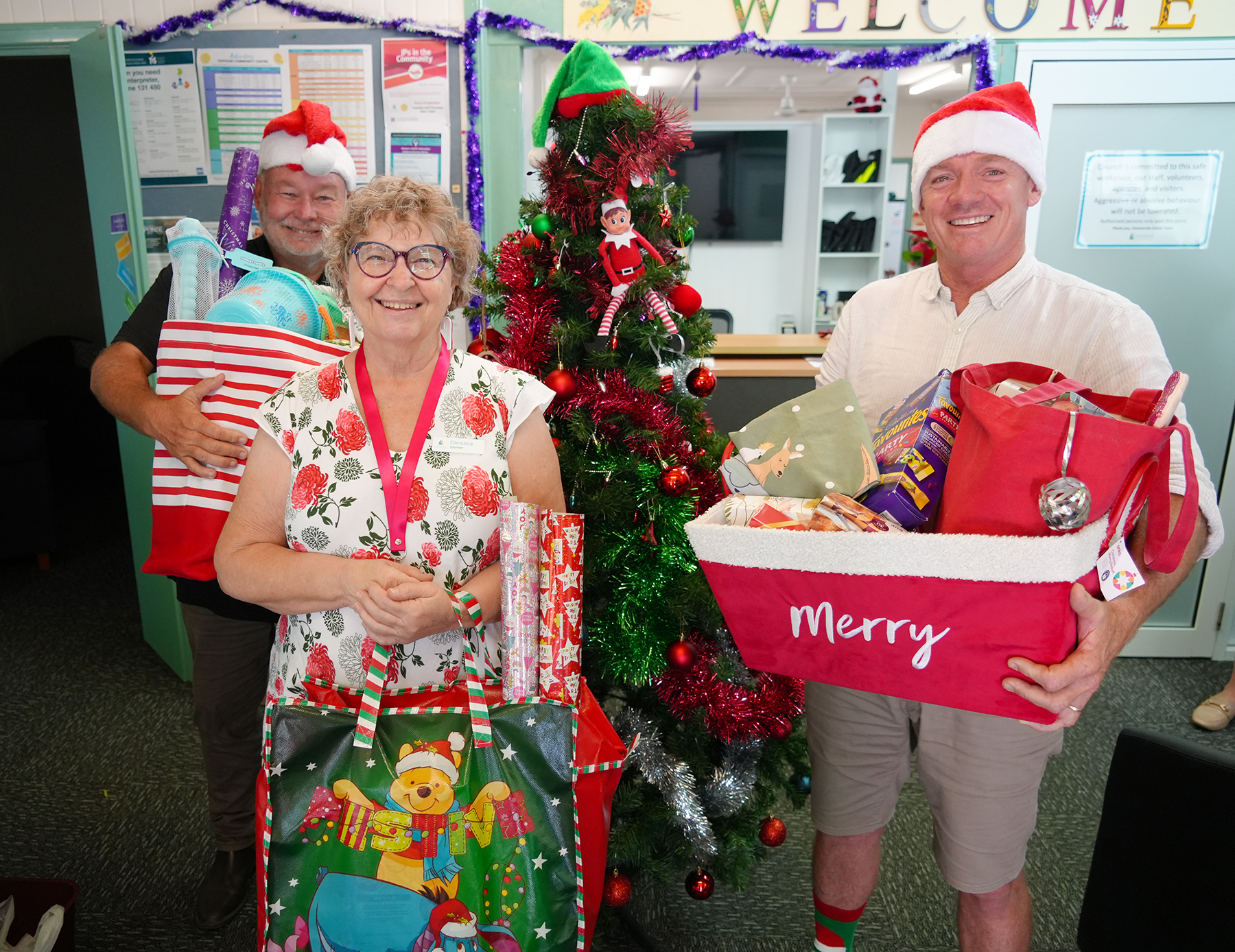 Cr rhodes watson community centre volunteer Christina and mayor adam belot at the Yeppoon community Centre for the mayor&#039;s Christmas giving tree appeal